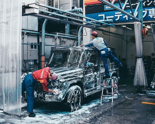 two-men-washing-black-suv